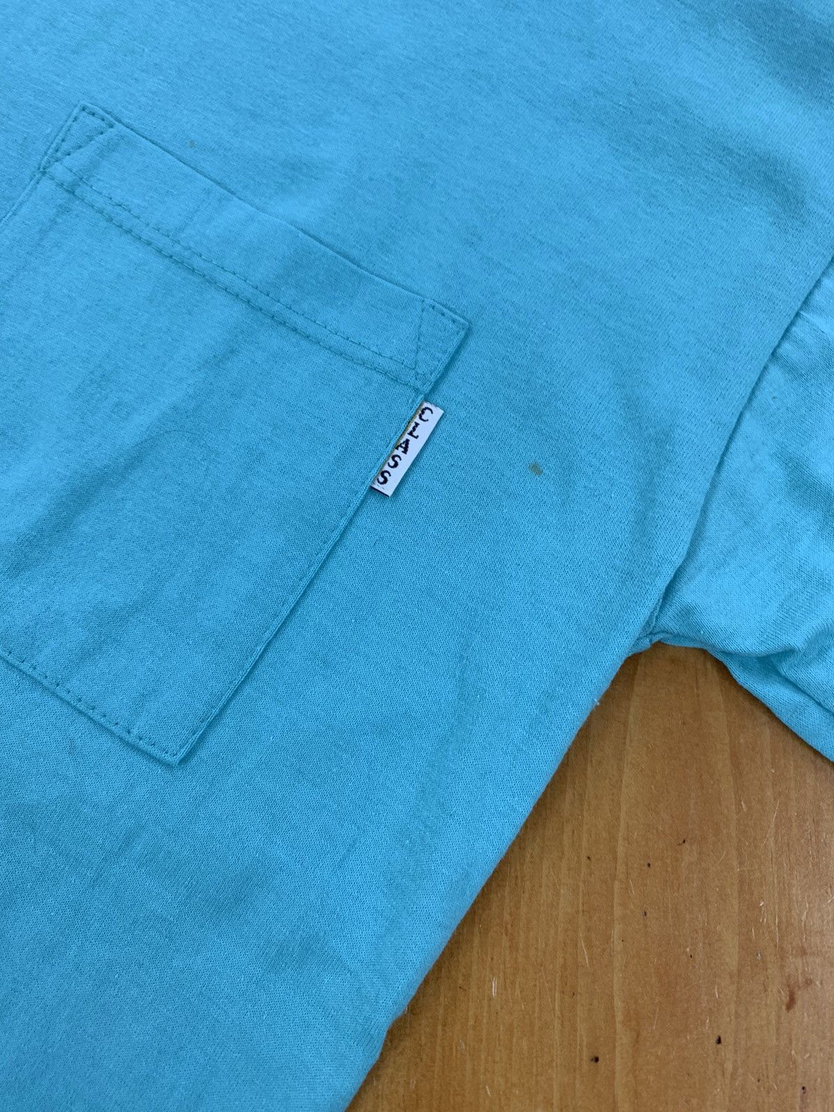Vintage 90s Classic Deadstock Teal Pocket Tee Hoodie, Sweatshirt | FlexRushtees.com